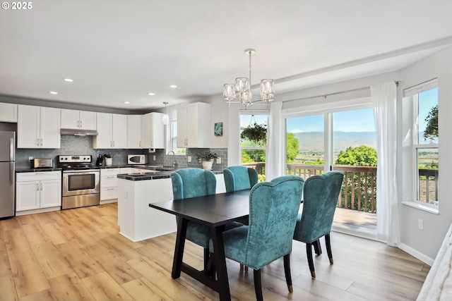 315 W 13th St, The Dalles, OR 97058 - dining area featuring a chandelier, light wood-type flooring, recessed lighting, and baseboards