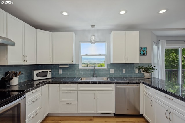 315 W 13th St, The Dalles, OR 97058 - kitchen featuring stainless steel appliances, a sink, tile countertops, white cabinetry, and recessed lighting