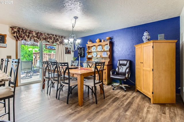1473 N Locust St, Canby, OR 97013 - dining space featuring a textured ceiling, a textured wall, a chandelier, and wood finished floors
