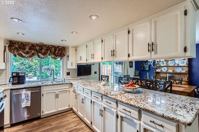 1473 N Locust St, Canby, OR 97013 - kitchen featuring dishwasher, a textured ceiling, white cabinets, light stone counters, and light wood finished floors