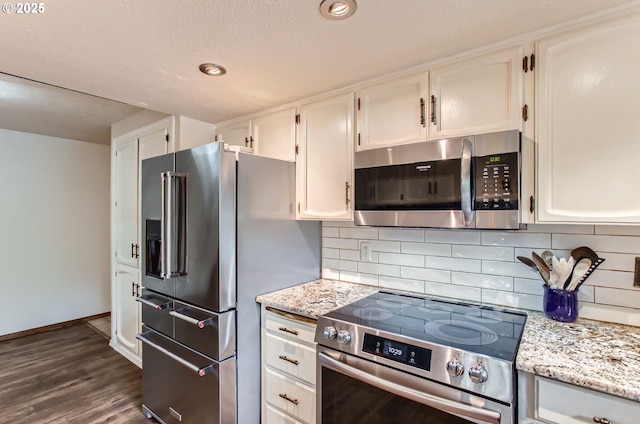 1473 N Locust St, Canby, OR 97013 - kitchen featuring appliances with stainless steel finishes, white cabinets, decorative backsplash, a textured ceiling, and recessed lighting