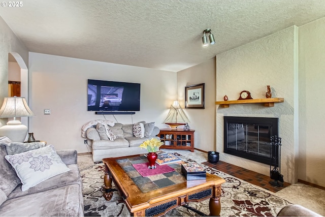 1473 N Locust St, Canby, OR 97013 - living area featuring a large fireplace, a textured ceiling, a textured wall, and arched walkways