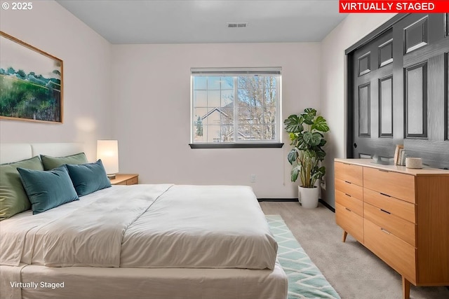 bedroom with light colored carpet and visible vents