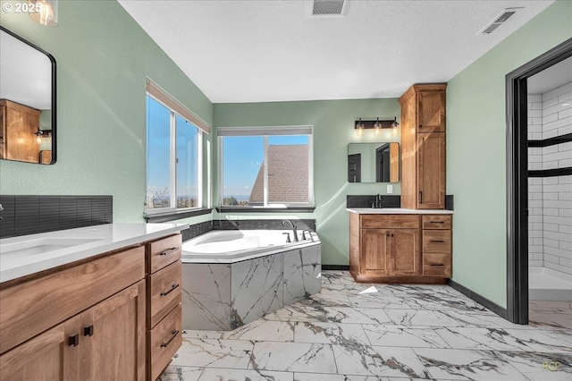 bathroom featuring a sink, visible vents, a garden tub, and marble finish floor