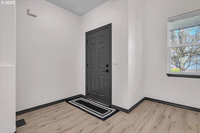 entrance foyer featuring light wood-style flooring and baseboards