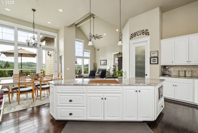 10448 SE 147th Ave, Happy Valley, OR 97086 - kitchen with high vaulted ceiling, dark wood-type flooring, healthy amount of natural light, a chandelier, and beamed ceiling
