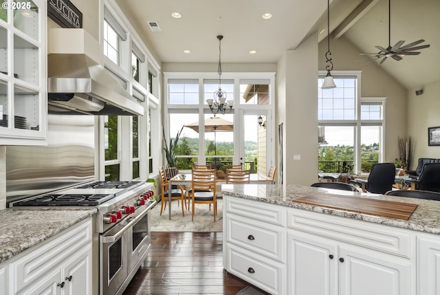 10448 SE 147th Ave, Happy Valley, OR 97086 - kitchen featuring range with two ovens, wall chimney range hood, high vaulted ceiling, dark wood finished floors, and beam ceiling