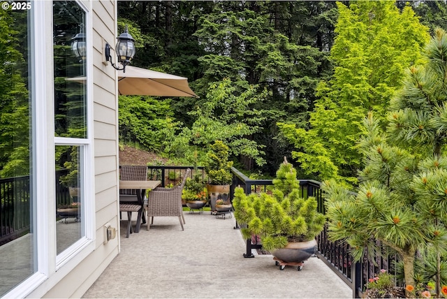 10448 SE 147th Ave, Happy Valley, OR 97086 - view of patio / terrace featuring outdoor dining area and view of wooded area