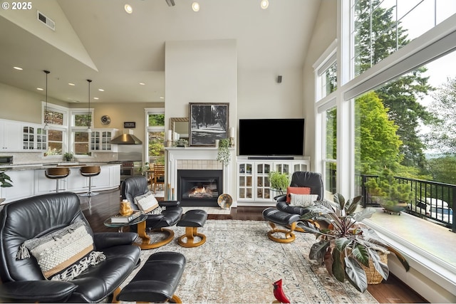 10448 SE 147th Ave, Happy Valley, OR 97086 - living room featuring high vaulted ceiling, wood finished floors, a fireplace, and recessed lighting