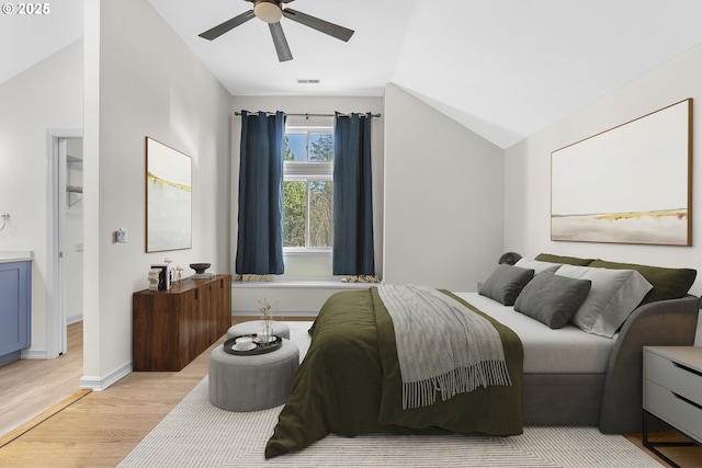 bedroom featuring lofted ceiling, ceiling fan, and light hardwood / wood-style flooring