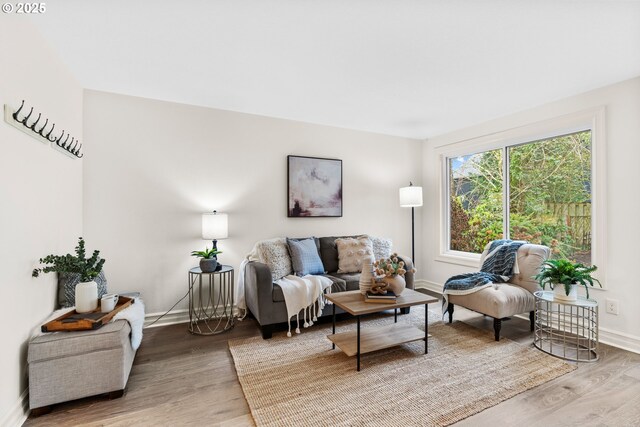 unfurnished bedroom featuring light hardwood / wood-style floors, ceiling fan, ensuite bath, and lofted ceiling