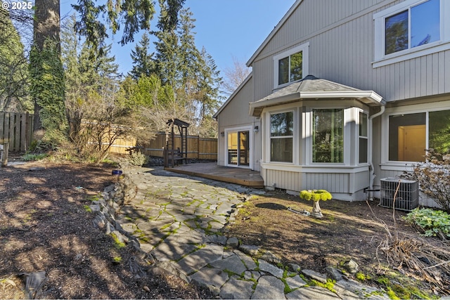 exterior space featuring a deck, a patio area, and central AC unit