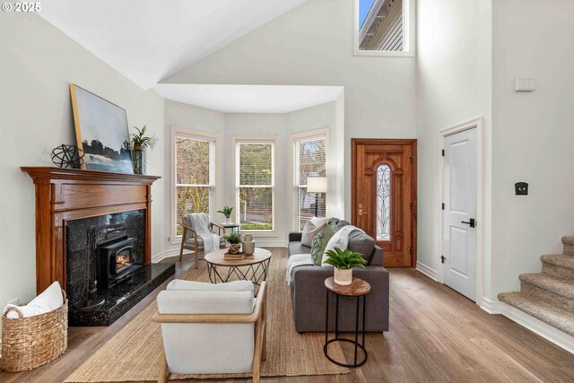 unfurnished living room with lofted ceiling and light wood-type flooring