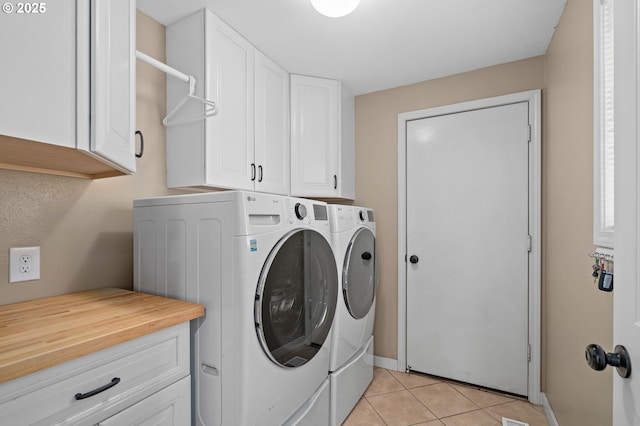 3113 SE 169th Ct, Vancouver, WA 98683 - laundry room featuring washing machine and dryer, cabinet space, light tile patterned flooring, and baseboards