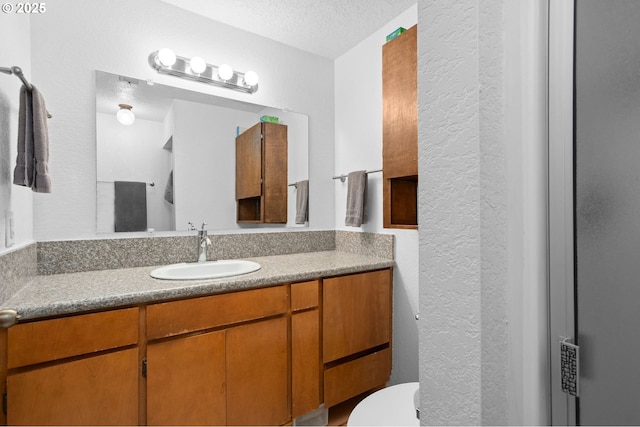 4775 Sienna Dr NE, Salem, OR 97301 - bathroom featuring a textured wall, vanity, and a textured ceiling