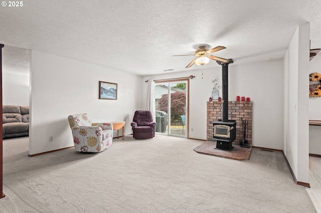 4775 Sienna Dr NE, Salem, OR 97301 - carpeted living area featuring ceiling fan, a textured ceiling, and a wood stove