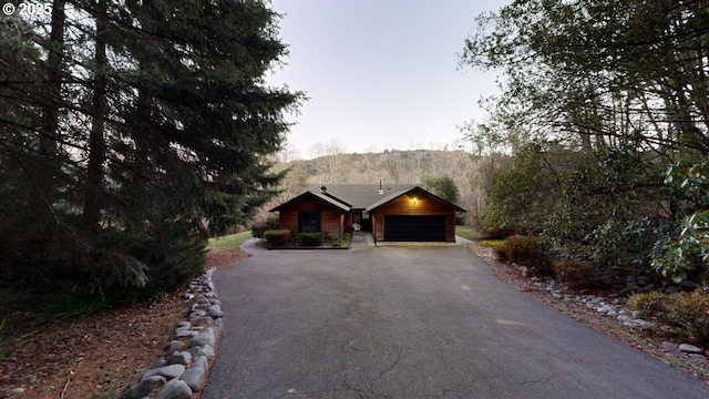 log home with a garage and a mountain view