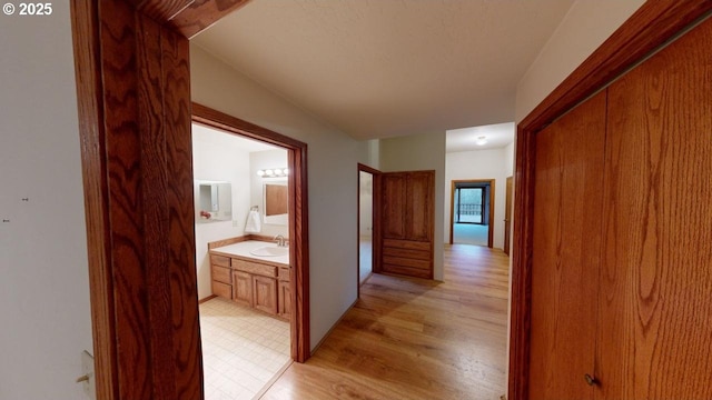 hall featuring sink and light hardwood / wood-style flooring