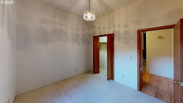 spare room with an inviting chandelier