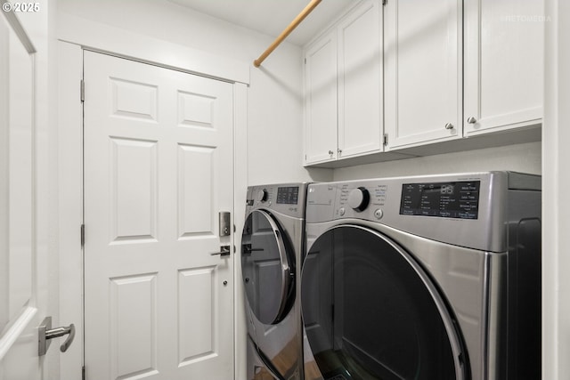 washroom featuring cabinet space and washer and dryer