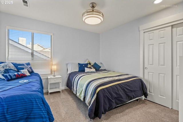 bedroom featuring carpet flooring, visible vents, and baseboards