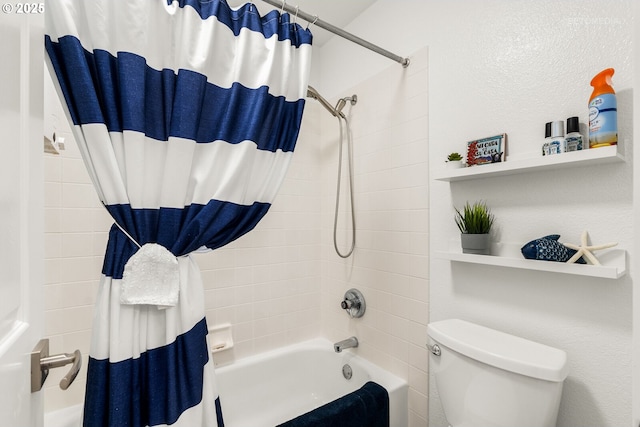 bathroom featuring shower / bath combination with curtain and toilet