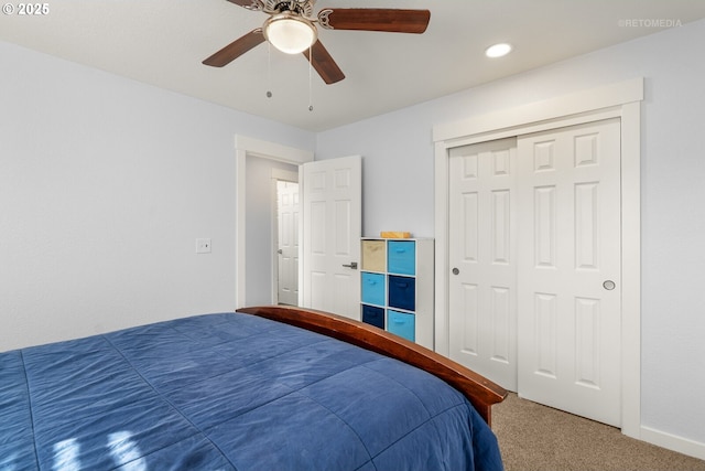 carpeted bedroom featuring a closet and a ceiling fan