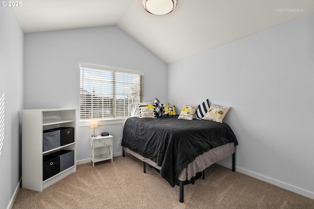 bedroom with carpet floors, vaulted ceiling, and baseboards