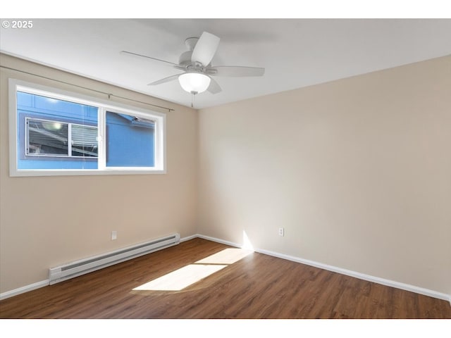 spare room with baseboards, baseboard heating, a ceiling fan, and wood finished floors