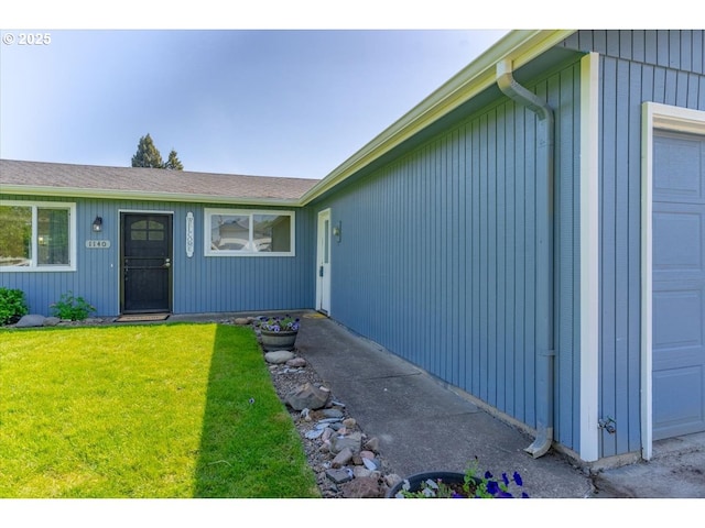 entrance to property with a lawn