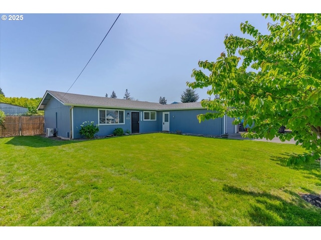 ranch-style home with a front lawn and fence