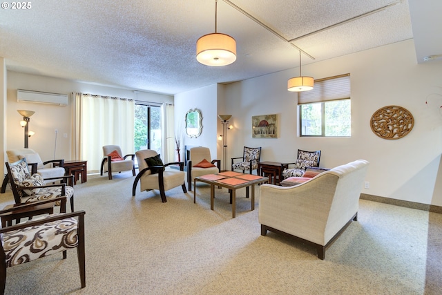 living room with an AC wall unit, a textured ceiling, and light carpet