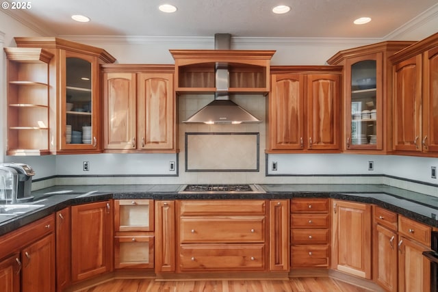 kitchen featuring light wood-style floors, stainless steel gas cooktop, open shelves, and wall chimney exhaust hood