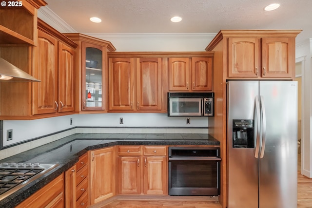 kitchen featuring brown cabinets, appliances with stainless steel finishes, ornamental molding, and glass insert cabinets