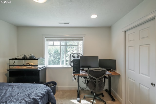 carpeted bedroom with visible vents and baseboards