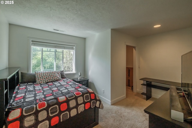carpeted bedroom featuring baseboards, recessed lighting, a textured ceiling, and visible vents