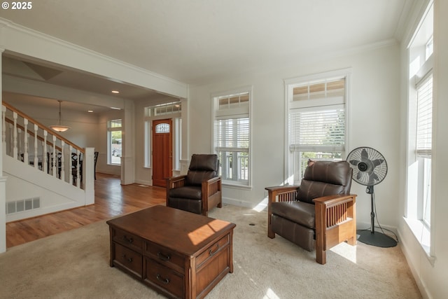living room with stairs, baseboards, visible vents, and ornamental molding