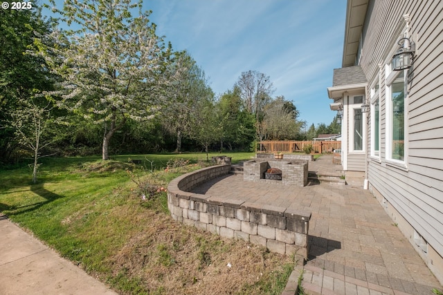 view of yard featuring a patio and an outdoor fire pit