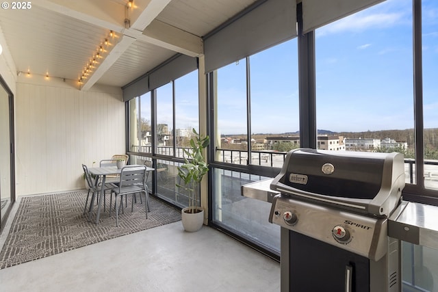 sunroom with beamed ceiling