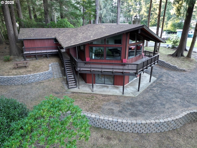 5346 Buckskin Bob, Florence, OR 97439 - back of house with a shingled roof, a chimney, and stairs