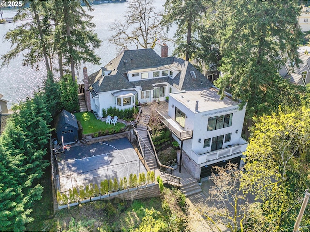 aerial view of property and surrounding area featuring a nearby body of water