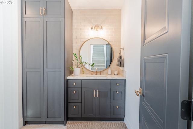 bathroom featuring baseboards, vanity, and a closet