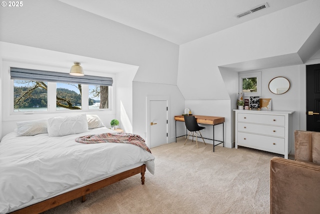 bedroom featuring light carpet, multiple windows, and lofted ceiling