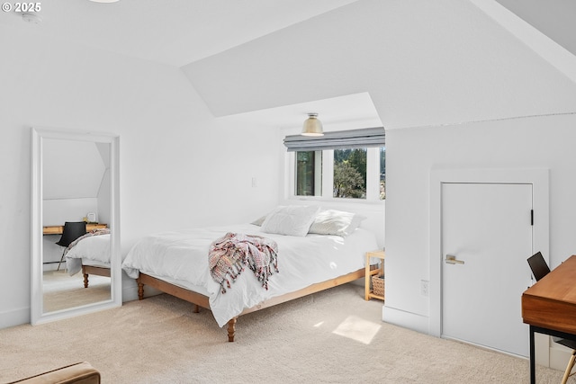 carpeted bedroom with vaulted ceiling
