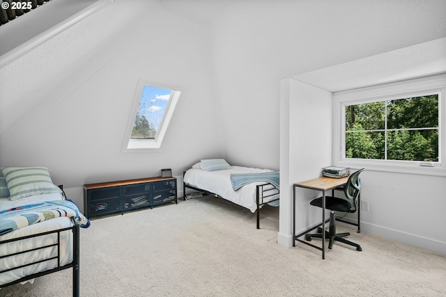 carpeted bedroom featuring a skylight, multiple windows, and baseboards