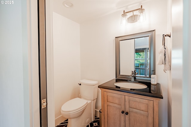 bathroom featuring toilet and vanity