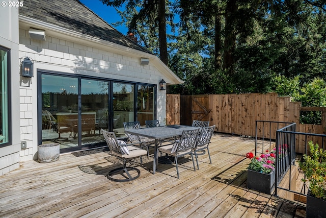 deck featuring outdoor dining space and fence