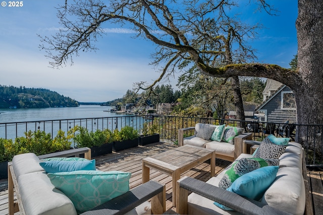 wooden deck with outdoor lounge area and a water view
