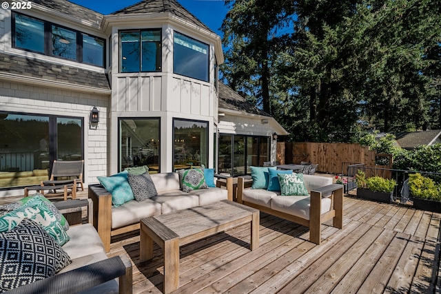 deck with outdoor lounge area and fence