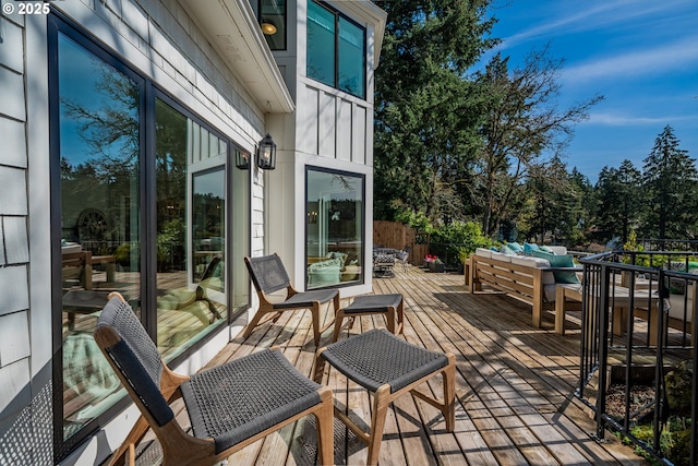 wooden terrace featuring an outdoor living space